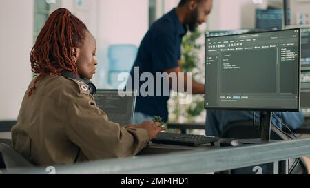 Software developer typing programming code on computer to develop online cloud computing information. Web programer writing html script and data algorithm on computer. Handheld shot. Stock Photo