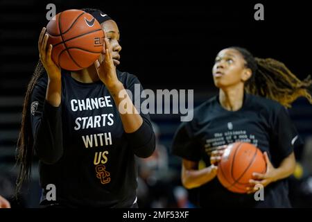 Southern California center Angel Jackson, left, wears a Change Starts With  Us shirt as she and teammates warm up before an NCAA college basketball  game against Stanford in Santa Cruz, Calif., Sunday