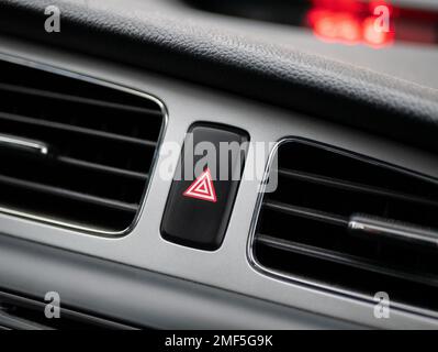 Hazard lights button on panel of auto, selective focus. Concept of hazard, problem, alert, danger, warning, emergency or alarm Stock Photo