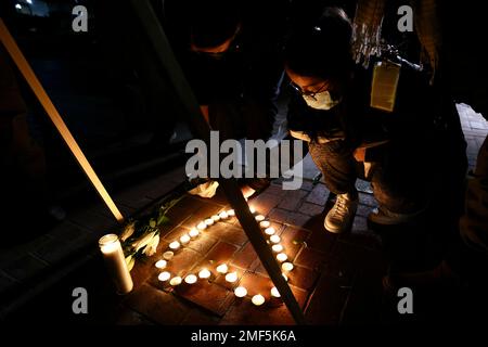 Monterey Park, USA. 24th Jan, 2023. A person places candles to mourn victims of a mass shooting in front of the city hall of Monterey Park, California, the United States, on Jan. 23, 2023. Hundreds of people gathered at the Monterey Park City Hall Monday evening for a memorial for the loss of the shooting which killed 11 and wounded nine. (Xinhua) Stock Photo