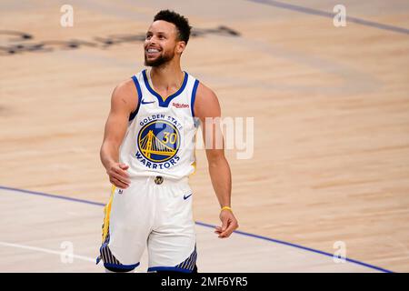 Stephen Curry (30) smiles after making another of his circus shots