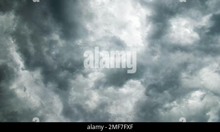 Dramatic sky background, thunderclouds in stormy weather, dark gray sky, moody natural cloudscape Stock Photo