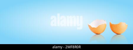 Egg shell isolated on white. Broken egg shell on light blue background Stock Photo