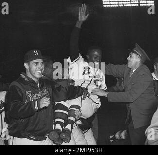 Milwaukee Braves' Hank Aaron is carried from the baseball field