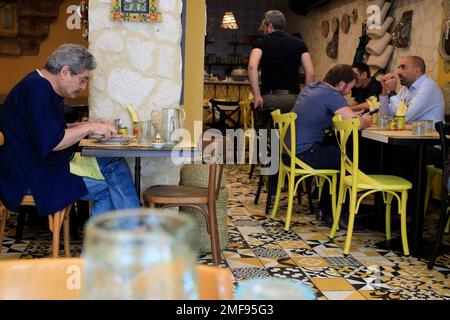 Customers eating lunch in an authentic Moroccan restaurant in 20th arrondissement.Paris.France Stock Photo