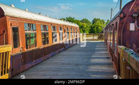 Passenger cars and old caboose stored at  historic Standish Michigan railroad depot Stock Photo