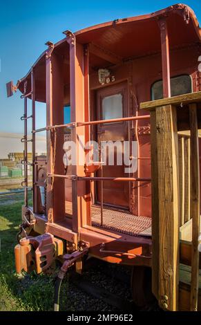 Passenger cars and old caboose stored at  historic Standish Michigan railroad depot Stock Photo