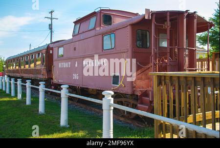 Passenger cars and old caboose stored at  historic Standish Michigan railroad depot Stock Photo