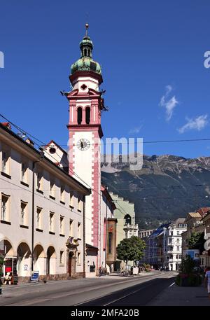 Maria-Theresien-Strasse (Innsbruck).On the left the bell tower of the Servitenkirche, known as the Servite Church of St. Joseph. Stock Photo