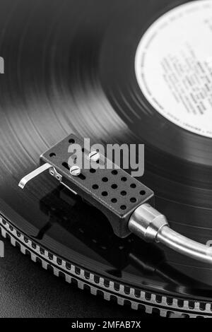 black vinyl record spinning on a vintage stereo turntable Stock Photo