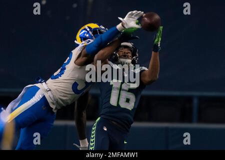 Los Angeles Rams safety Nick Scott knocks away a pass intended for Seattle  Seahawks wide receiver Tyler Lockett during the second half of an NFL  wild-card playoff football game, Saturday, Jan. 9,