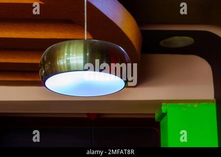 steel colored lamp hanging from the ceiling Stock Photo