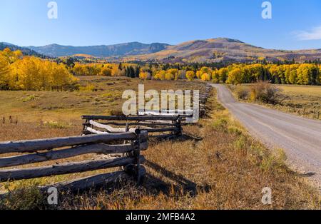 Autumn Country Road - Autumn view of colorful rolling hills and ranch land at side of Owl Creek Pass Road, Ridgway, Colorado, USA. Stock Photo