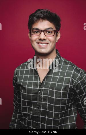 A cheerful Arabic man confidently posing for the camera, radiating joy and assurance. His happy expression symbolizes trust, and reliability. Stock Photo