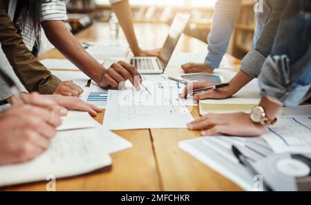 Study session. High angle shot of a group of unrecognizable university students studying in the library. Stock Photo