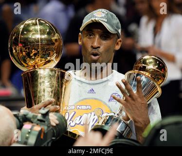 Los Angeles Lakers Kobe Bryant, left, holding the championship trophy,  celebrates with teammates Rick Fox, Lindsey Hunter, second from right, and  Shaquille O'Neal, right, holding the MVP trophy, after winning Game 4