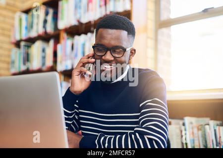 Come to the library, I have all the answers. a university student doing some research on a laptop. Stock Photo