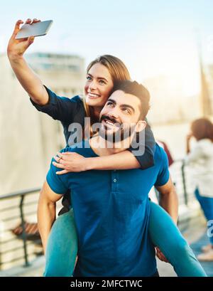 Selfies with my sweetheart. a young couple taking a selfie outside. Stock Photo