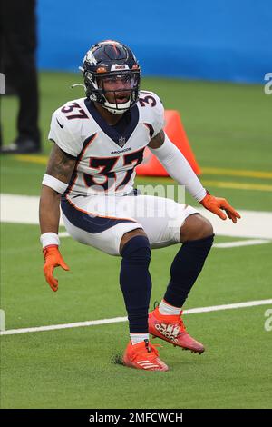 Nine-month-old James Locke IV, right, is held by his father, Denver Broncos  defensive back P.J. Locke (37) after taking part in drills at an NFL  football training camp at team headquarters Saturday