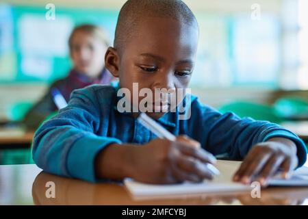 Little minds with great thoughts. an elementary school boy working in class. Stock Photo