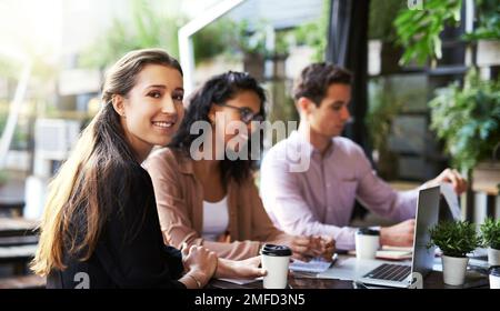 Success is discussed better over a cup of coffee. Portrait of a young designer having a meeting with her colleagues at a coffee shop. Stock Photo
