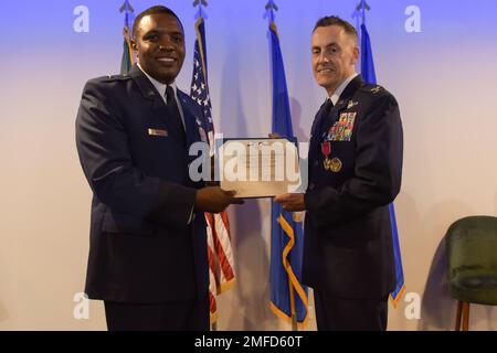 U.S. Air Force Brig. Gen. Otis C. Jones, left, 86th Airlift Wing commander, presents Col. William Wallis, right, 65th Air Base Group outgoing commander, a Legion of Merit oak leaf cluster certificate during a change of command ceremony at Lajes Field, Portugal, Aug. 19, 2022. The Legion of Merit medal is awarded to service members who have distinguished themselves through meritorious conduct. Stock Photo