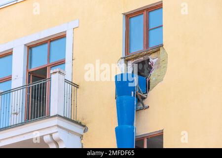 Pipe for debris, waste tube. Blue telescope rubble chute. Plastic garbage chute fixed on facade. Repair in apartment, office of old historical buildin Stock Photo