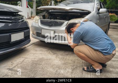 Man Upset and Sit down Motorist In Crash For Crash Insurance Fraud Getting Out Of Car Stock Photo