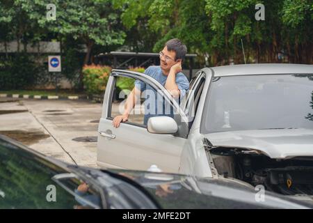 Man Upset and Sit down Motorist In Crash For Crash Insurance Fraud Getting Out Of Car Stock Photo