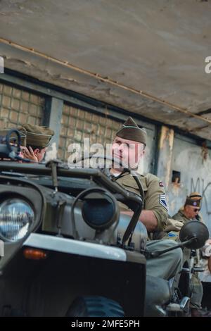 Hel, Poland - August 2022 Military troops marching during 3 May Polish Constitution Day ceremonial patriotic parade. Polish armed forces tanker military parade. Old guns and cars. Feast of Polish Armed Forces Day, American soldiers with US flag on parade Nato Vehicles Military Equipment  Stock Photo