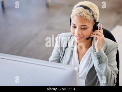 Top view, call center and black woman in office, customer support for telemarketing, help or consulting. African American female agent, lady or Stock Photo