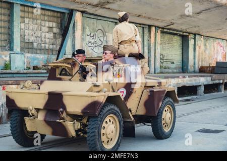 Hel, Poland - August 2022 Military troops marching during 3 May Polish Constitution Day ceremonial patriotic parade. Polish armed forces tanker military parade. Old guns and cars. Feast of Polish Armed Forces Day, American soldiers with US flag on parade Nato Vehicles Military Equipment  Stock Photo