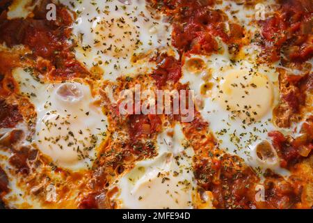 Home made Shakshuka, traditional North African and Middle Eastern dish close up, background Stock Photo