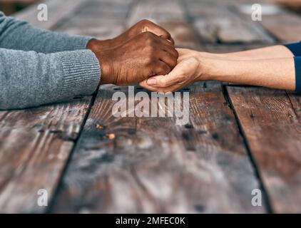 Never let go of what sets you free. two unrecognizable people holding hands. Stock Photo