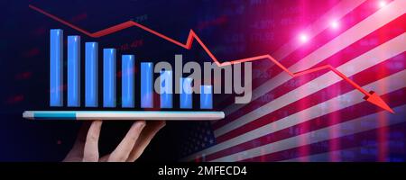 Falling stock chart emerges from a tablet that a man holds with falling arrow against the backdrop of the US flag Stock Photo