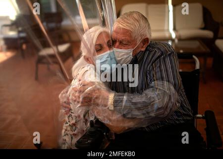 Dolores Reyes Fernández, 61, caresses her father's face José Reyes Lozano,  87, for the first time in nearly four months as visits resume to a nursing  home in Barcelona, Spain, Monday, June