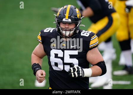 Iowa offensive lineman Tyler Linderbaum (65) gets set to snap the ball  during the first half of an NCAA college football game against Indiana,  Saturday, Sept. 4, 2021, in Iowa City, Iowa. (