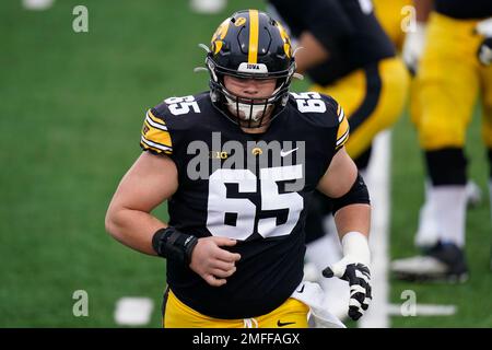 Iowa offensive lineman Tyler Linderbaum (65) gets set to snap the ball  during the first half of an NCAA college football game against Indiana,  Saturday, Sept. 4, 2021, in Iowa City, Iowa. (