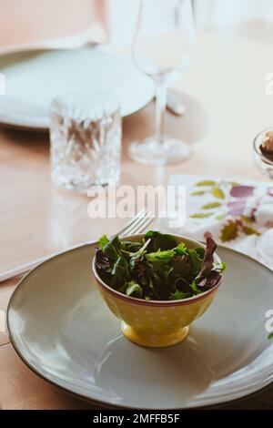 A vertical shot of the modern table setting with delicious healthy salads Stock Photo