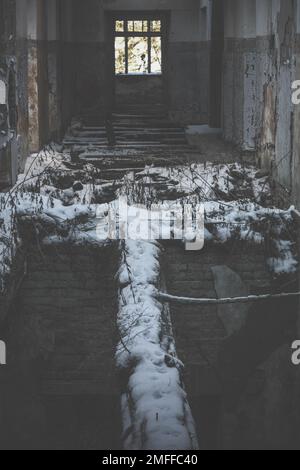 Close up abandoned house corridor with destroyed snowed wooden floor concept photo Stock Photo