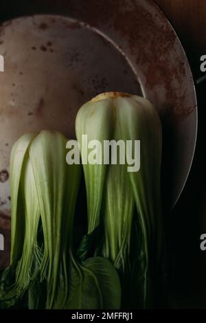 Bok choy in old rusty pan, top view Stock Photo