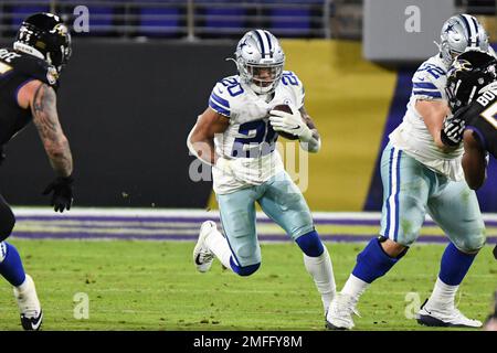 Dallas Cowboys running back Tony Dorsett (33) gets stopped at the line of  scrimmage by New Orleans Saints linebacker Jim Kovech (52) and defensive  tackle Derland Moore (74) during second half action