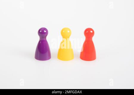 Different leisure game pawn figures concept for diverse group of people on white background Stock Photo