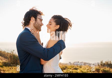 Love, wedding and bride with groom on mountain for marriage ceremony, commitment and celebration. Romance, happiness and interracial couple bonding Stock Photo