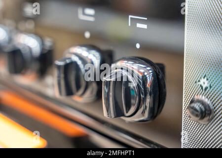 handle for turning on the burner of home kitchen stove. Home gas stove Stock Photo