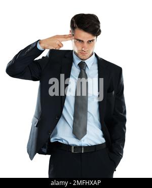 Businessman, depression and hand gun to the head in studio for stress against a white background. Anxiety, suicide and young entrepreneur suffering Stock Photo