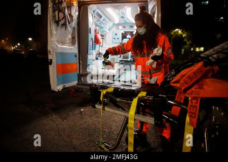 Medical volunteer Beatrice Ammattatiello sanitizes the ambulance