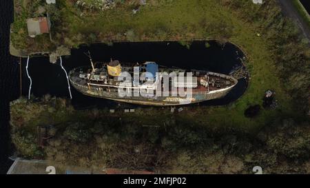 General views of the MV Naomh Eanna, an old ship that ferried people to and from the Aran Islands decades ago, which has capsized in the Grand Canal dock in Dublin. The MV Naomh Eanna was built in Dublin in the 1950s and was the main mode of transport connecting Co Galway to the Aran Islands from the 1960s until the 1980s. Despite plans to salvage the ship being mooted over the years, including making it part of a Maritime Quarter in Dublin, it has been left to languish. Picture date: Wednesday January 25, 2023. Stock Photo