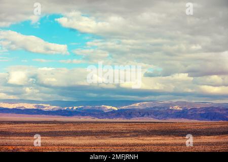 Evening cloudy sky over mountain desert. Negev desert in Israel  view at Jordan from moving car Stock Photo