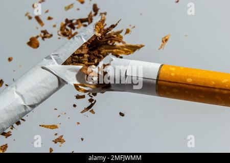 Broken cigarette fly in air on a light background. Conception of combating smoking. Stock Photo